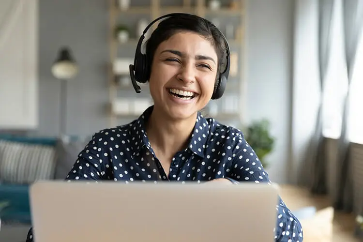 Customer service rep working from home and smiling.