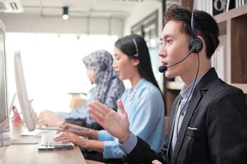 Person With Others Working For Answering Service